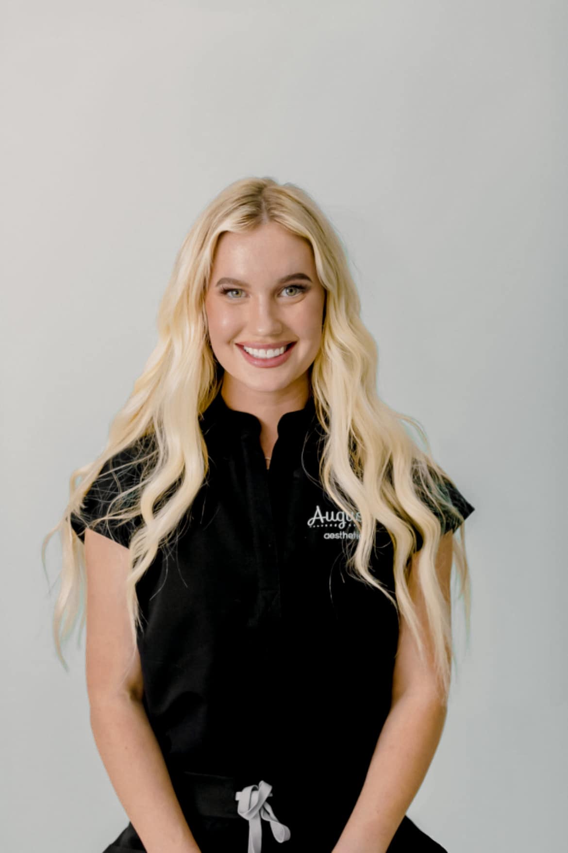 Hannah Simms, NP, Augusta Aesthetics wearing Black Figs Scrubs Medical Provider